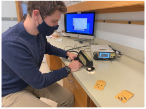 Lance Stasinski taking spectral measurements in Dr. Meireles’s lab using an SVC spectroradiometer.