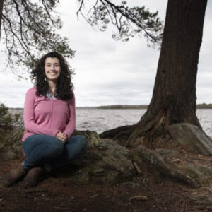 Rachel Fowler sitting on a lakeshore