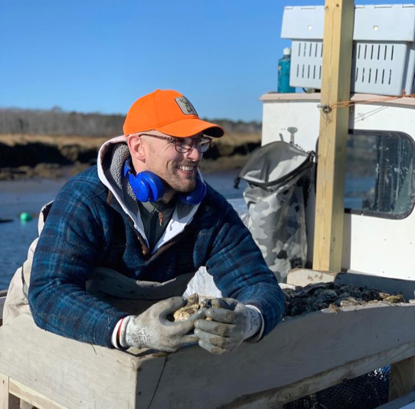 Photo of Adam Copeland on a research boat
