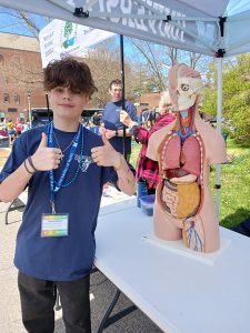 Winner of SBE's anatomy torso reassembly challenge: Stephan Mladek, holding his thumbs up and smiling, at Windstorm Challenge 2024