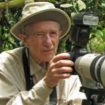 Ron Davis wearing a sun hat and holding a camera with a telephoto lens