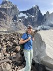 Miranda Seixas with a backpack, against a mountainous background