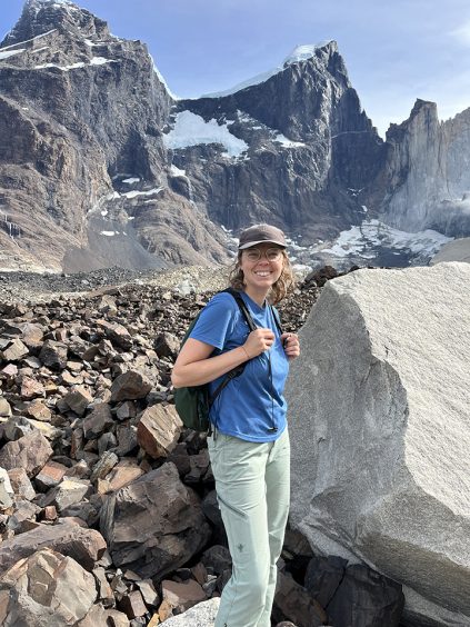 Miranda Seixas with a backpack, against a mountainous background